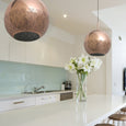 Modern kitchen with a copper brass pendant light