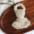 Close up of a tassel napkin ring on a wooden board