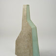 Close up of a geometric vase with a teal accent