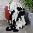 Black and white textured blanket on a stool