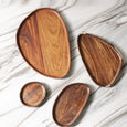 Four wooden leaf-shaped trays in different sizes