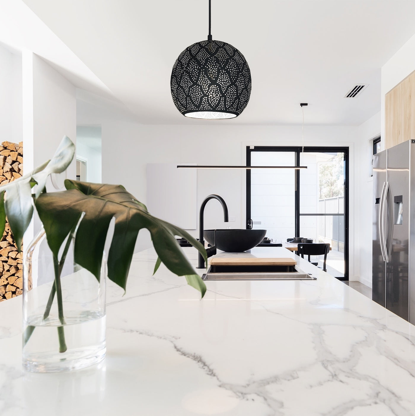 Modern kitchen with a rounded metal pendant light