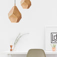 Office with hanging pendant light and artwork