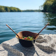 Mahogany salad bowl near a lake