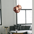 Monochrome living room with three copper pendant lights