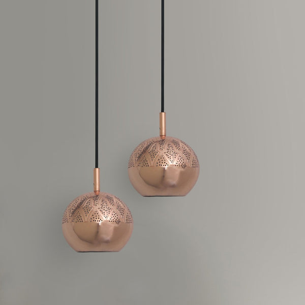 Two copper patterned pendant lights