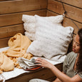 Woman in a wooden bench grabbing fabric napkins