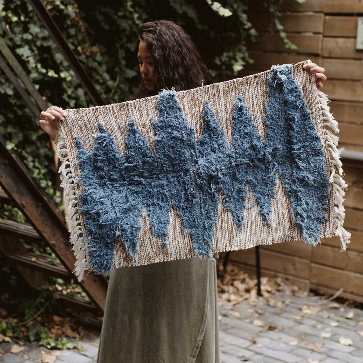 Woman holding cotton woven rug