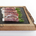 Slate and wood platter with appetizers on top