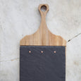 Close up of a slate and wood paddle board on a marble countertop