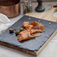 Slate and wood paddle serving board with appetizers