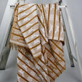 Handwoven patterned throw on a ladder