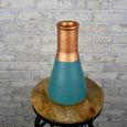 Teal and copper beaker-shaped vase on a wooden stool 