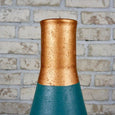 Close up of a teal and copper vase