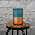 Teal and copper tube vase on a wooden stool