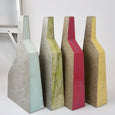 Four geometric vases in different colours