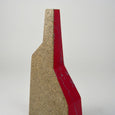 Close up of a geometric vase with a red accent