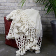 Ivory wool blanket on a leather stool 
