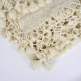 Close up of ivory wool blanket tassles