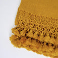 Close up of a tumeric-coloured wool blanket