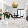 Modern kitchen with a rounded brass pendant light